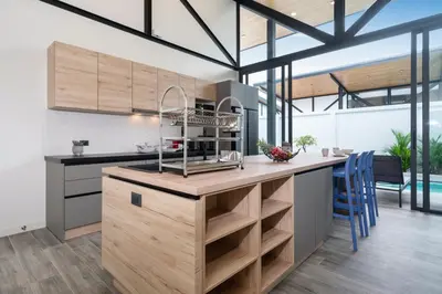 a kitchen with a large island with a counter top at NEW! Sleek Design Oxygen Pool Villa 3 BR - Sunset Garden 14 in Ban Saiyuan (1)