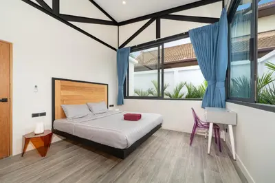 a bedroom with a bed and two large windows at NEW! Sleek Design Oxygen Pool Villa 3 BR - Sunset Garden 14 in Ban Saiyuan (1)