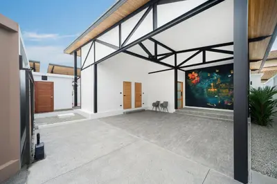 an outdoor patio with a mural on the side of a house at NEW! Sleek Design Oxygen Pool Villa 3 BR - Sunset Garden 14 in Ban Saiyuan (1)