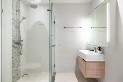 a bathroom with a glass shower and a sink at Bangtao Beach Tropical Holiday Retreat in Bang Tao Beach
