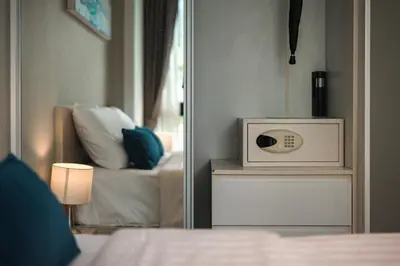 a mirror reflection of a bedroom with a microwave at Bangtao Beach Tropical Holiday Retreat in Bang Tao Beach
