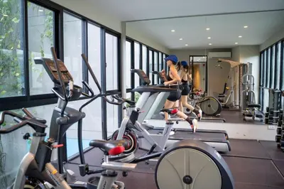 a group of people in a gym on a bike at Bangtao Beach Tropical Holiday Retreat in Bang Tao Beach