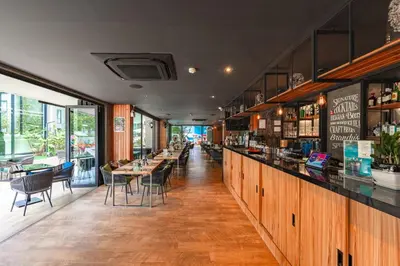 a bar with tables and chairs in a restaurant at Bangtao Beach Tropical Holiday Retreat in Bang Tao Beach