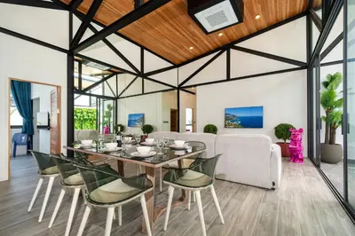 a dining room with a table and chairs at Stylish Eco Villa Sunset Garden 1E with Private Pool near Nai Harn Beach in Ban Saiyuan (1)