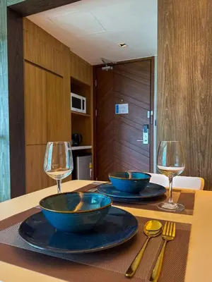 two bowls on a table with two wine glasses at Large Lux Studio in La Vita 5-star Rawai in Rawai Beach