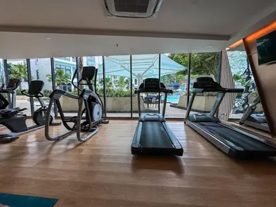 a gym with several treadmills and elliptical machines at Large Lux Studio in La Vita 5-star Rawai in Rawai Beach