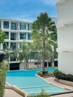 an image of a swimming pool in front of a building at Large Lux Studio in La Vita 5-star Rawai in Rawai Beach