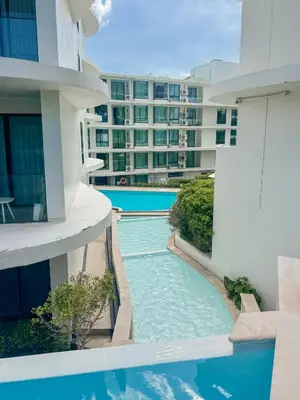 a swimming pool in the middle of a building at Large Lux Studio in La Vita 5-star Rawai in Rawai Beach