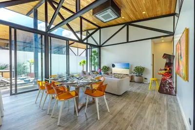 a dining room with a table and chairs at Modern 4-Bedroom Solar Villa with Pool & Game Zone at Sunset Garden 15 in Rawai Beach
