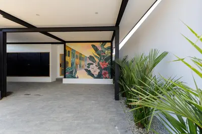 a building with paintings on the wall and plants at Modern 4-Bedroom Solar Villa with Pool & Game Zone at Sunset Garden 15 in Rawai Beach