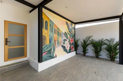 an empty room with a painting on the wall at Modern 4-Bedroom Solar Villa with Pool & Game Zone at Sunset Garden 15 in Rawai Beach