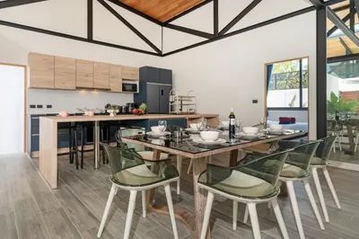 a dining room with a table and chairs at Sunset Garden 16 - Eco Design Villa with Private Pool near Nai Harn Beach in Rawai Beach