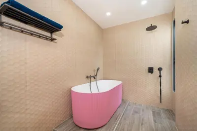 a bathroom with a pink tub and a shower at Sunset Garden 16 - Eco Design Villa with Private Pool near Nai Harn Beach in Rawai Beach