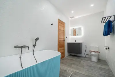 a bathroom with a bath tub and a toilet at Sunset Garden 16 - Eco Design Villa with Private Pool near Nai Harn Beach in Rawai Beach