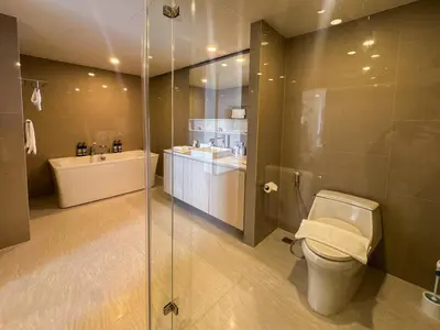 a bathroom with a shower and a toilet and a sink at Luxury 5-star Duplex in La Vita Sea View in Rawai Beach