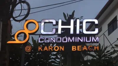 a neon sign in the window of a restaurant at Karon Chic Seashore Apartment in Karon Beach