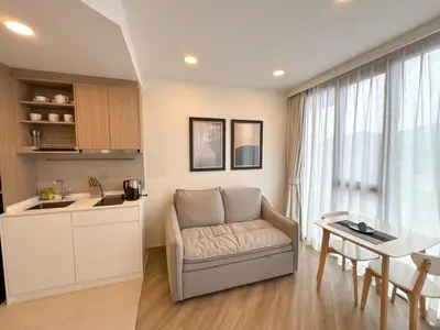 a kitchen and living room with a couch and a table at Laguna Skypark 1BR Apartment garden view NEW in Laguna Phuket
