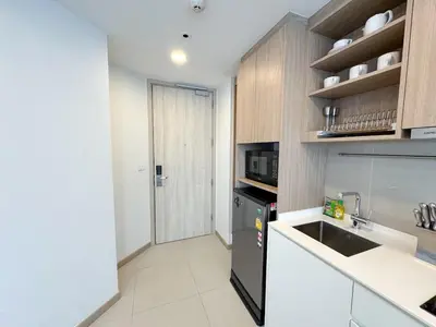a kitchen with a sink and a black refrigerator at Laguna Skypark 1BR Apartment garden view NEW in Laguna Phuket