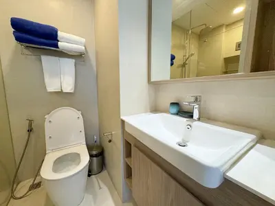 a bathroom with a sink and a toilet and a mirror at Laguna Skypark 1BR Apartment garden view NEW in Laguna Phuket
