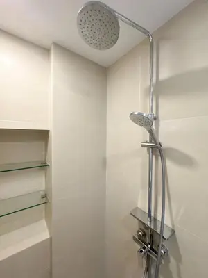 a shower with a shower head in a bathroom at Laguna Skypark 1BR Apartment garden view NEW in Laguna Phuket