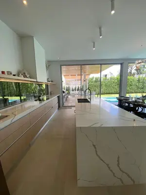a large kitchen with a large marble counter top at Minimalist luxury villa in Ban Klang