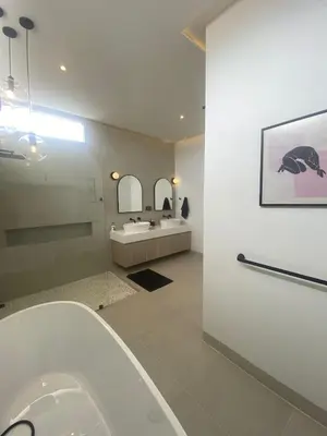 a bathroom with a white tub and a sink at Minimalist luxury villa in Ban Klang