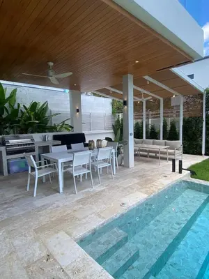 a patio with a table and chairs and a pool at Minimalist luxury villa in Ban Klang