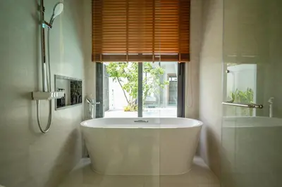 a bath tub in a bathroom with a window at Mouana Residence Song Khun Chalong 4-bedroom Pool Villa 896 in Chalong