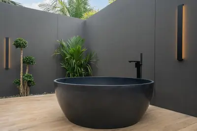 a black tub sitting on top of a wooden floor at Cocoon Villa 5 - Luxurious 3BR Pool Retreat near Naithon Beach in Nai Thon Beach