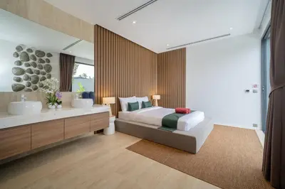 a bedroom with a bed and a tub and a sink at Cocoon Villa 5 - Luxurious 3BR Pool Retreat near Naithon Beach in Nai Thon Beach