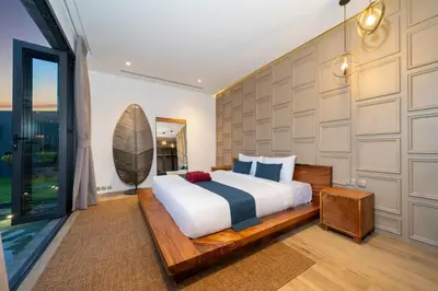 a bedroom with a large bed and a large window at Cocoon Villa 5 - Luxurious 3BR Pool Retreat near Naithon Beach in Nai Thon Beach