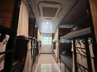 an empty room with bunk beds in an rv at By the Beach Hostel in Phi Phi Don