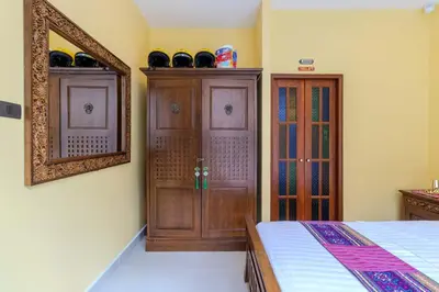 a bedroom with a bed and a mirror and a cabinet at V225 Spacious 3BR Villa Pool and Garden Near Beach in Rawai Beach