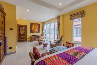 a dining room with yellow walls and a table and chairs at V225 Spacious 3BR Villa Pool and Garden Near Beach in Rawai Beach