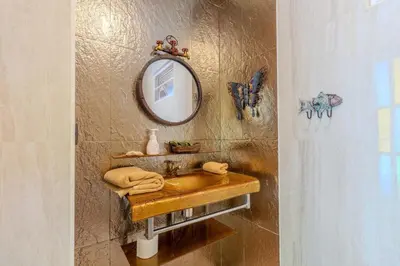 a bathroom with a sink and a mirror on the wall at V225 Spacious 3BR Villa Pool and Garden Near Beach in Rawai Beach
