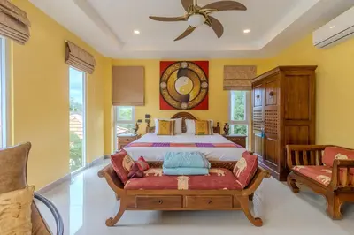 a bedroom with a bed and a ceiling fan at V225 Spacious 3BR Villa Pool and Garden Near Beach in Rawai Beach