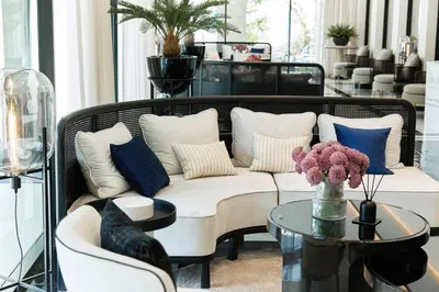 a living room with a white couch and blue pillows at Title Legendary, 1-BR, 45 sqm, 8 min to BangTao Beach in Bang Tao Beach