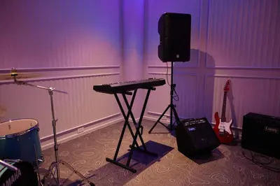 a room with a keyboard and a speaker and guitars at Title Legendary, 1-BR, 45 sqm, 8 min to BangTao Beach in Bang Tao Beach
