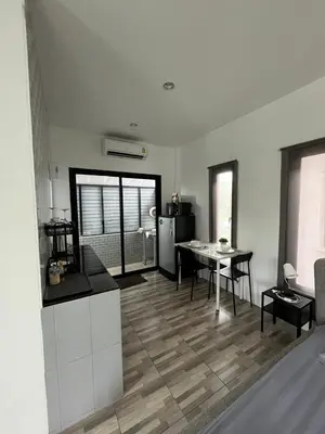 a kitchen and dining room with a table and a refrigerator at Vista Loft Bang Tao in Ban Thalat Choeng Thale