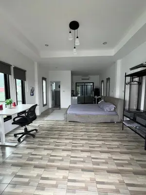 a bedroom with a bed and a desk and a table at Vista Loft Bang Tao in Ban Thalat Choeng Thale