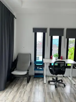 an office with a desk and chairs and windows at Vista Loft Bang Tao in Ban Thalat Choeng Thale