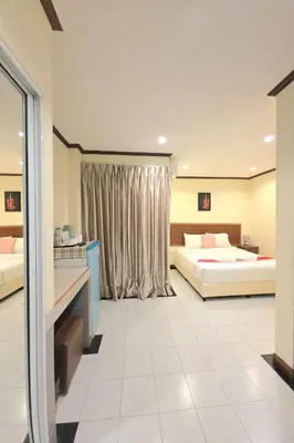 a large bedroom with two beds and a window at A&N Residence Patong in Patong Beach