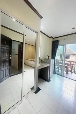 a room with glass doors and a view of a bedroom at A&N Residence Patong in Patong Beach