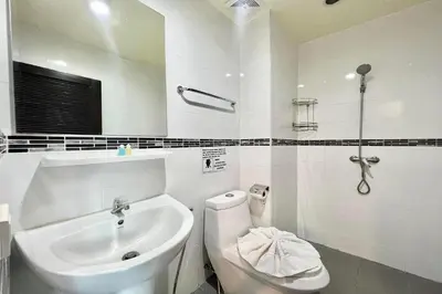 a white bathroom with a sink and a toilet at A&N Residence Patong in Patong Beach