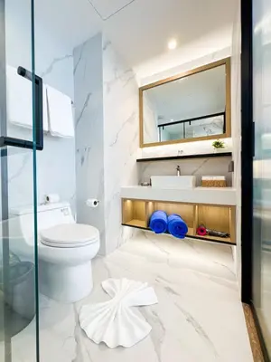 a bathroom with a toilet and a sink and a mirror at New Modern 1Bdr Laya 500 m to the Beach in Layan Beach