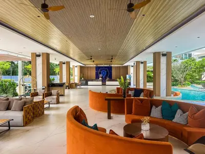 an open lobby with couches and tables and a pool at New Modern 1Bdr Laya 500 m to the Beach in Layan Beach
