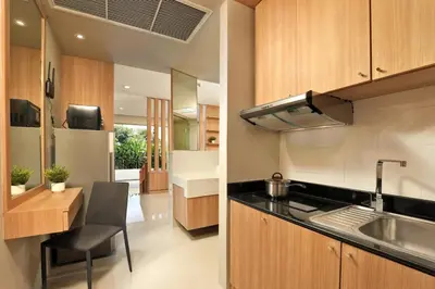 a kitchen with a sink and a stove at Spacious studio with access to the pool in Karon Hill condo in Karon Beach