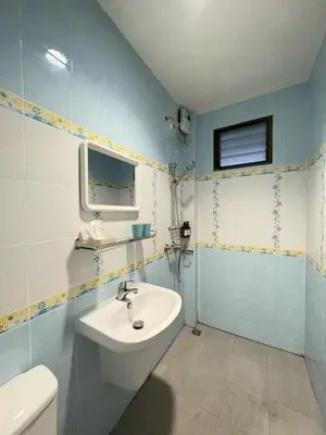 a bathroom with a sink and a toilet at RisaVilla Phuket - 4BR Pool Villa near Patong Beach in Patong Beach