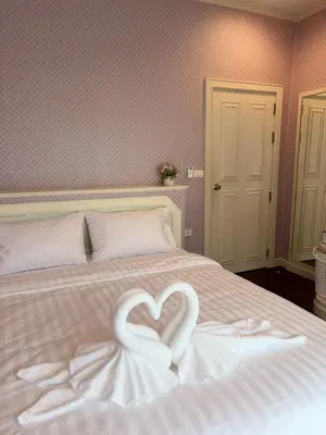 a bed with two white swans forming a heart at RisaVilla Phuket - 4BR Pool Villa near Patong Beach in Patong Beach