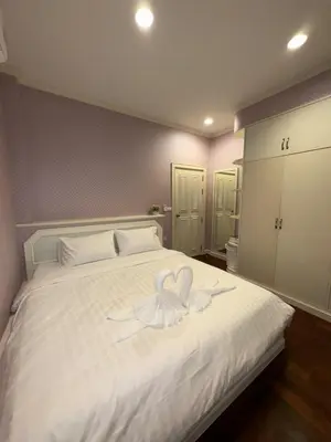 a white bed with a heart shaped towel on it at RisaVilla Phuket - 4BR Pool Villa near Patong Beach in Patong Beach